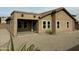 Backyard view featuring a covered patio and a low-maintenance gravel landscape at 45737 W Ranch Rd, Maricopa, AZ 85139