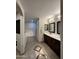 Spacious bathroom with a dual sink vanity, walk-in shower, and decorative tile flooring inlay at 45737 W Ranch Rd, Maricopa, AZ 85139