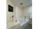 Relaxing soaking tub with tile surround and decorative accents on the wall at 45737 W Ranch Rd, Maricopa, AZ 85139