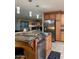 Open kitchen features stainless appliances, granite counters, and island with bar seating at 45737 W Ranch Rd, Maricopa, AZ 85139