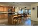 Open kitchen features granite counters, island with bar seating, stainless appliances, and adjacent dining area at 45737 W Ranch Rd, Maricopa, AZ 85139