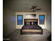 This room features a decorative bed frame, plush bedding, modern light fixture, and natural light at 45737 W Ranch Rd, Maricopa, AZ 85139