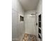 Modern walk-in shower with elegant marble-style tiling and built-in shelving at 45737 W Ranch Rd, Maricopa, AZ 85139