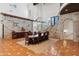 Dining area with rustic table, custom chandelier, stone accent wall, and staircase at 21868 E Stacey Rd, Queen Creek, AZ 85142