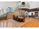 Dining area features a custom chandelier, natural stone walls, and access to elevator at 21868 E Stacey Rd, Queen Creek, AZ 85142