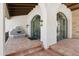 Arched entry with decorative water feature and clay tile flooring at 21868 E Stacey Rd, Queen Creek, AZ 85142