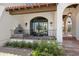 Inviting front porch with arched walkway and decorative water feature at 21868 E Stacey Rd, Queen Creek, AZ 85142