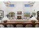 Comfortable living room with grand fireplace, high ceilings and beautiful chandelier lighting at 21868 E Stacey Rd, Queen Creek, AZ 85142
