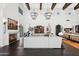Open floor plan of living area with beamed ceilings, fireplace, gourmet kitchen, and grand sofa at 21868 E Stacey Rd, Queen Creek, AZ 85142