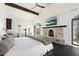 Elegant main bedroom featuring a fireplace and access to private outdoor space at 21868 E Stacey Rd, Queen Creek, AZ 85142