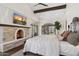 Comfortable main bedroom features a stone fireplace and French doors to the patio at 21868 E Stacey Rd, Queen Creek, AZ 85142