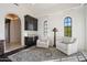 Relaxing sitting area with two armchairs and built-in wet bar at 21868 E Stacey Rd, Queen Creek, AZ 85142