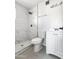 Updated bathroom showcasing marble-tiled shower and a white vanity with modern fixtures at 4333 N 59 Th Ave, Phoenix, AZ 85033