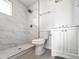 Modern bathroom with a walk-in shower featuring elegant marble tile and a contemporary vanity at 4333 N 59 Th Ave, Phoenix, AZ 85033