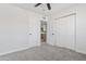 Comfortable bedroom featuring neutral carpeting, a ceiling fan, and convenient closet space at 4333 N 59 Th Ave, Phoenix, AZ 85033