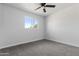 Cozy bedroom with plush carpeting, a ceiling fan, and a window offering natural light at 4333 N 59 Th Ave, Phoenix, AZ 85033