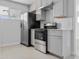 Modern kitchen featuring gray cabinets, stainless steel appliances, and a sleek white countertop at 4333 N 59 Th Ave, Phoenix, AZ 85033