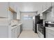 Modern kitchen featuring gray cabinets, stainless steel appliances, and a sleek white countertop at 4333 N 59 Th Ave, Phoenix, AZ 85033