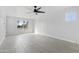 Spacious living room filled with natural light, featuring tile flooring and a modern ceiling fan at 4333 N 59 Th Ave, Phoenix, AZ 85033