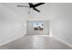 Inviting living area featuring tile flooring, a modern ceiling fan, and large windows for natural light at 4333 N 59 Th Ave, Phoenix, AZ 85033