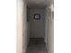 Hallway with tile flooring and white cabinetry along the left at 3802 N 79Th Ave, Phoenix, AZ 85033