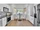 Bright kitchen with a breakfast nook and white cabinets at 13308 N 93Rd Pl, Scottsdale, AZ 85260