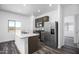Bright kitchen featuring stainless steel appliances, granite countertops, and wood-look floors at 24594 W St Catherine Ave, Buckeye, AZ 85326