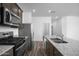 Modern kitchen with stainless steel appliances, granite countertops, and wood-look flooring at 24594 W St Catherine Ave, Buckeye, AZ 85326