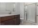 Bathroom featuring a vanity, toilet, and tiled shower with a glass door at 19539 E Estrella Rd, Queen Creek, AZ 85142