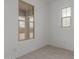 Bright bedroom with two windows and tile flooring at 19539 E Estrella Rd, Queen Creek, AZ 85142