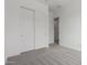 A bedroom with bright trim, neutral carpet, and sliding closet doors at 19539 E Estrella Rd, Queen Creek, AZ 85142