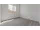 A light, bright bedroom with gray carpet, white walls, and a view from the window at 19539 E Estrella Rd, Queen Creek, AZ 85142