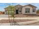 Charming single-story home showcasing a stone facade and well-maintained landscaping in a peaceful neighborhood at 19539 E Estrella Rd, Queen Creek, AZ 85142
