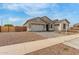 Beautiful one story home featuring a three car garage and nicely manicured landscaping at 19539 E Estrella Rd, Queen Creek, AZ 85142