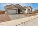 Charming single-Gathering home featuring a paver driveway, a two-car garage, and stone accents on the front elevation at 19539 E Estrella Rd, Queen Creek, AZ 85142