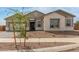 Charming single-Gathering home featuring a two-car garage and a front yard with desert landscaping at 19539 E Estrella Rd, Queen Creek, AZ 85142