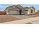 Charming single-Gathering home featuring a paver driveway, a two-car garage, and stone accents on the front elevation at 19539 E Estrella Rd, Queen Creek, AZ 85142