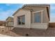 Close-up of a single-Gathering home with stone accents, desert landscaping, and large windows at 19539 E Estrella Rd, Queen Creek, AZ 85142