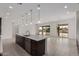 Bright open-concept kitchen with a large island, dark wood cabinets, and modern pendant lighting at 19539 E Estrella Rd, Queen Creek, AZ 85142