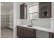 Walk-in pantry boasts white shelving and a convenient sink area with dark wood cabinets at 19539 E Estrella Rd, Queen Creek, AZ 85142