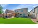 Beautiful backyard with a covered patio, fire pit, seating area, and artificial grass at 2920 E Shady Spring Trl, Phoenix, AZ 85024