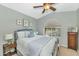 Bright bedroom with arched window, ceiling fan, and comfortable furnishings create a relaxing retreat at 2920 E Shady Spring Trl, Phoenix, AZ 85024