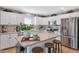 Bright kitchen featuring a spacious island with bar seating, stainless steel appliances, and white cabinetry at 2920 E Shady Spring Trl, Phoenix, AZ 85024