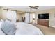 Main bedroom features barn doors, ceiling fan and a view into the home office through an open doorway at 2920 E Shady Spring Trl, Phoenix, AZ 85024