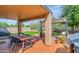Relaxing covered patio with a dining area, stylish furniture, string lights, and low-maintenance landscaping at 2920 E Shady Spring Trl, Phoenix, AZ 85024