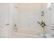 Bathroom featuring a tub and shower with white tiles at 7358 E Red Hawk St, Mesa, AZ 85207