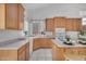 Well-appointed kitchen with light oak cabinets and white countertops, with view of the backyard at 7358 E Red Hawk St, Mesa, AZ 85207