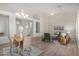 Open-concept living and dining area with neutral color palette, light hardwood floors and abundant natural light at 7358 E Red Hawk St, Mesa, AZ 85207