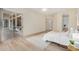 Bright main bedroom with wood floors and sliding glass door to the screened-in lanai at 7358 E Red Hawk St, Mesa, AZ 85207