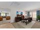 Bright home office features a large desk, comfortable chair, and views into the living area at 17214 W Gibson Ln, Goodyear, AZ 85338